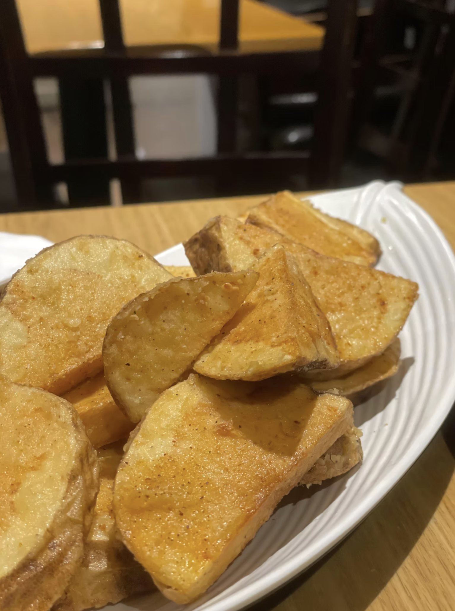 Golden, seasoned potato wedges, crispy on the outside and tender inside.