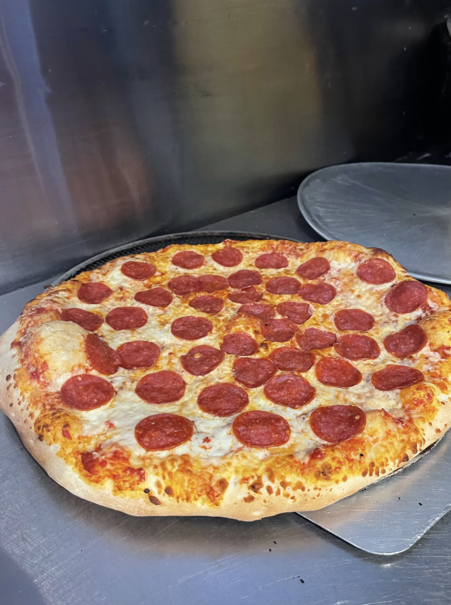A freshly baked pepperoni pizza with a golden, cheesy crust and plenty of pepperoni.